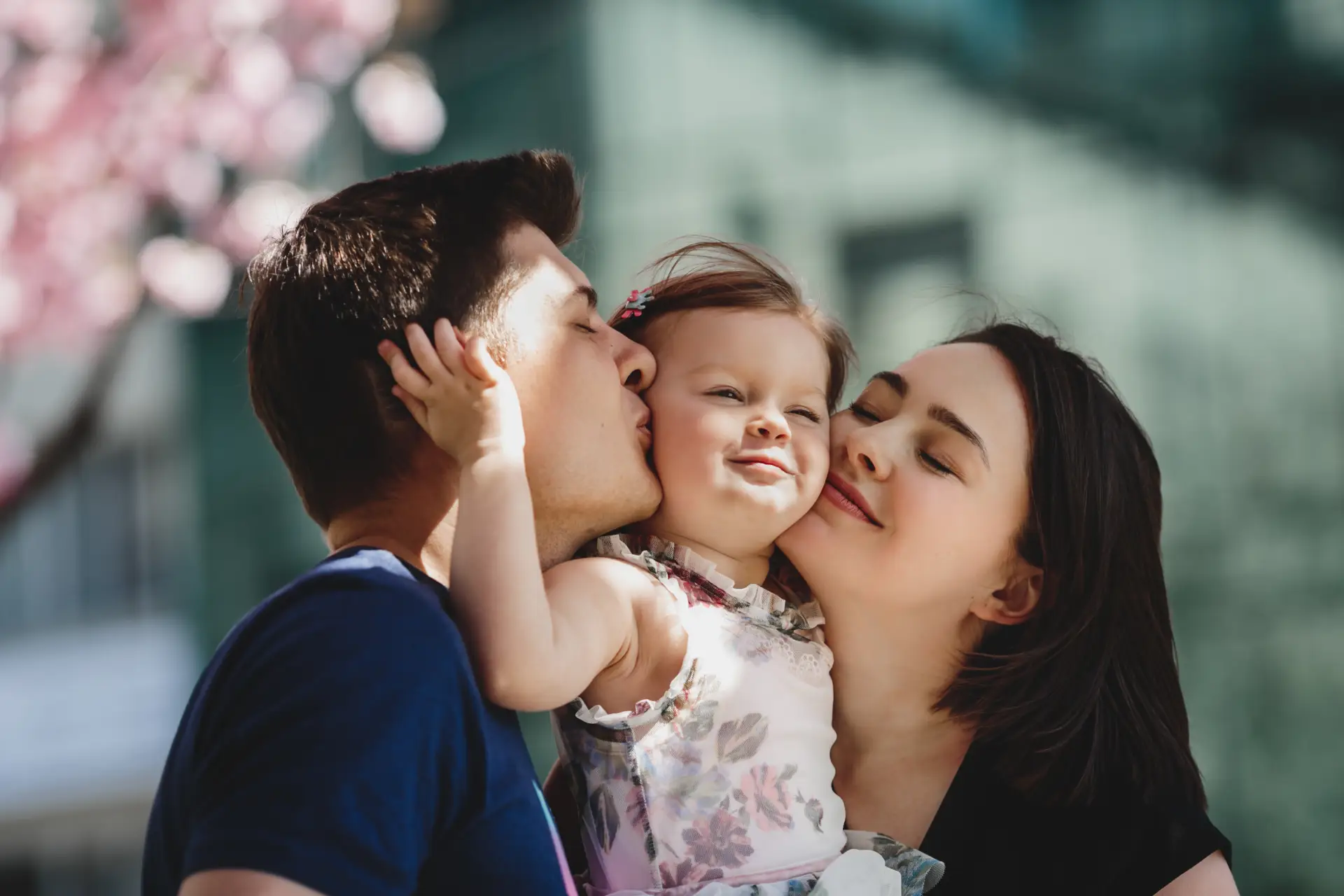 parents embracing their smiling child, symbolizing the essence of family law